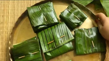Bhetki Paturi wrapped in banana leaves, coated with mustard paste